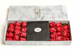 A close-up image of 24 beautiful red roses from Vancouver's Box Des Fleurs arranged in an infinity symbol shape, with stems meeting in the middle in a Luxury Marble Box. The elegant white marble complements the roses' natural beauty, adding a touch of sophistication to any space. Order now for fresh, handcrafted flowers from Vancouver's premier florist.