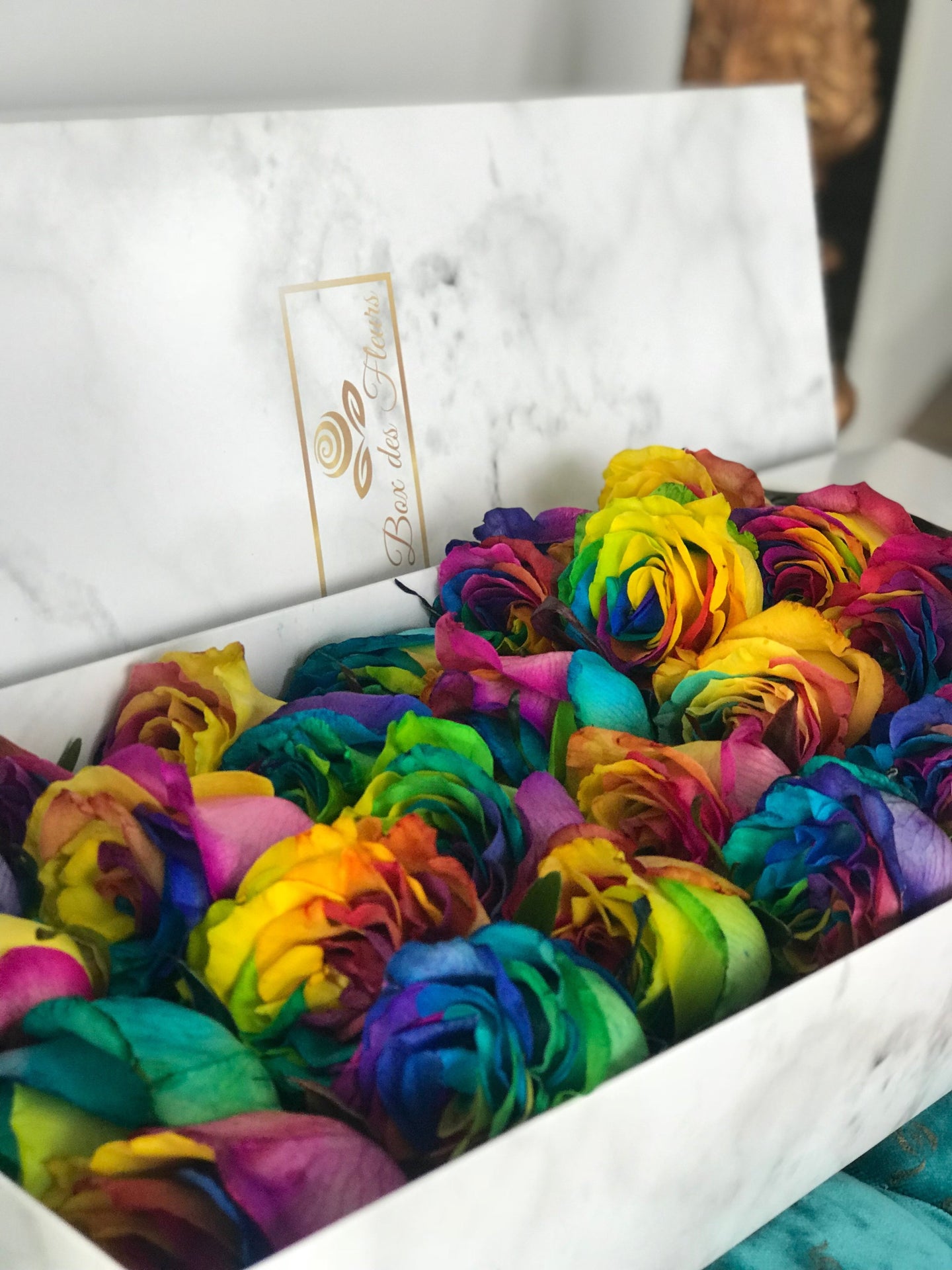 A close-up image of 24 rainbow from Vancouver's Box Des Fleurs in a Luxury Marble Box. The elegant white marble complements the rose's natural beauty. Perfect for a sophisticated and romantic gift or decoration. Order now for fresh, handcrafted flowers from Vancouver's premier florist.