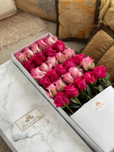 A close-up of 30 roses in a luxury marble box by Vancouver's Box des Fleeurs. The arrangement has an alternating color combination of bridal pink and magenta pink roses.