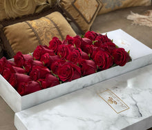 A close-up image of 24 red roses from Vancouver's Box Des Fleurs in a Luxury Marble Box. The elegant white marble complements the rose's natural beauty. Perfect for a sophisticated and romantic gift or decoration. Order now for fresh, handcrafted flowers from Vancouver's premier florist.