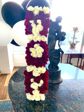 A close-up image of a flower arrangement in a white marble box from Vancouver's Box Des Fleurs, arranged to spell out "MOM" with stunning red, white flowers. The letters are in red, adding a pop of color to the elegant and creative design. This arrangement is perfect for gifting on Mother's Day or any occasion to show appreciation for a special mother in your life.
