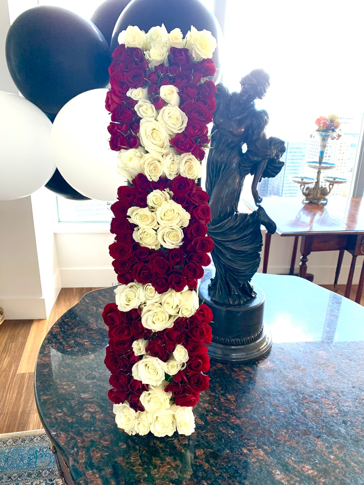 A close-up image of a flower arrangement in a white marble box from Vancouver's Box Des Fleurs, arranged to spell out 