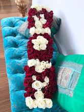 A close-up image of a flower arrangement in a white marble box from Vancouver's Box Des Fleurs, arranged to spell out "MOM" with stunning red, white flowers. The letters are in red, adding a pop of color to the elegant and creative design. This arrangement is perfect for gifting on Mother's Day or any occasion to show appreciation for a special mother in your life.