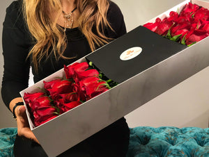 A close-up image of 24 beautiful red roses from Vancouver's Box Des Fleurs arranged in an infinity symbol shape, with stems meeting in the middle in a Luxury Marble Box. The elegant white marble complements the roses' natural beauty, adding a touch of sophistication to any space. Order now for fresh, handcrafted flowers from Vancouver's premier florist.